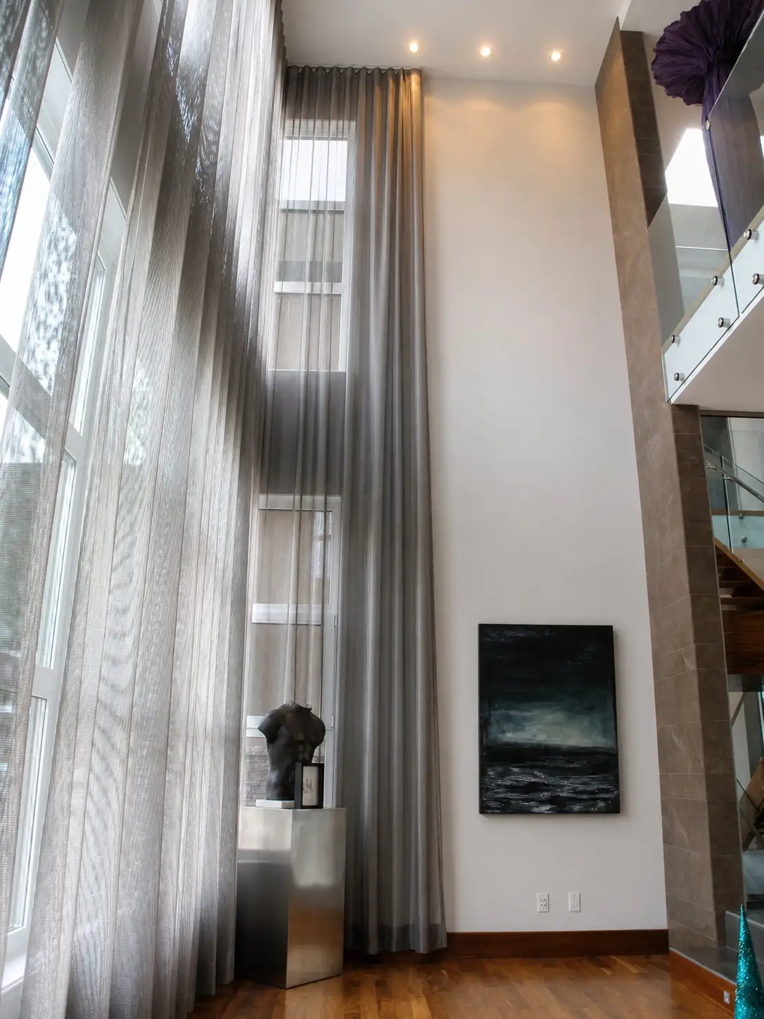 Double-height drapery beside a full-height window in the Windsor residence